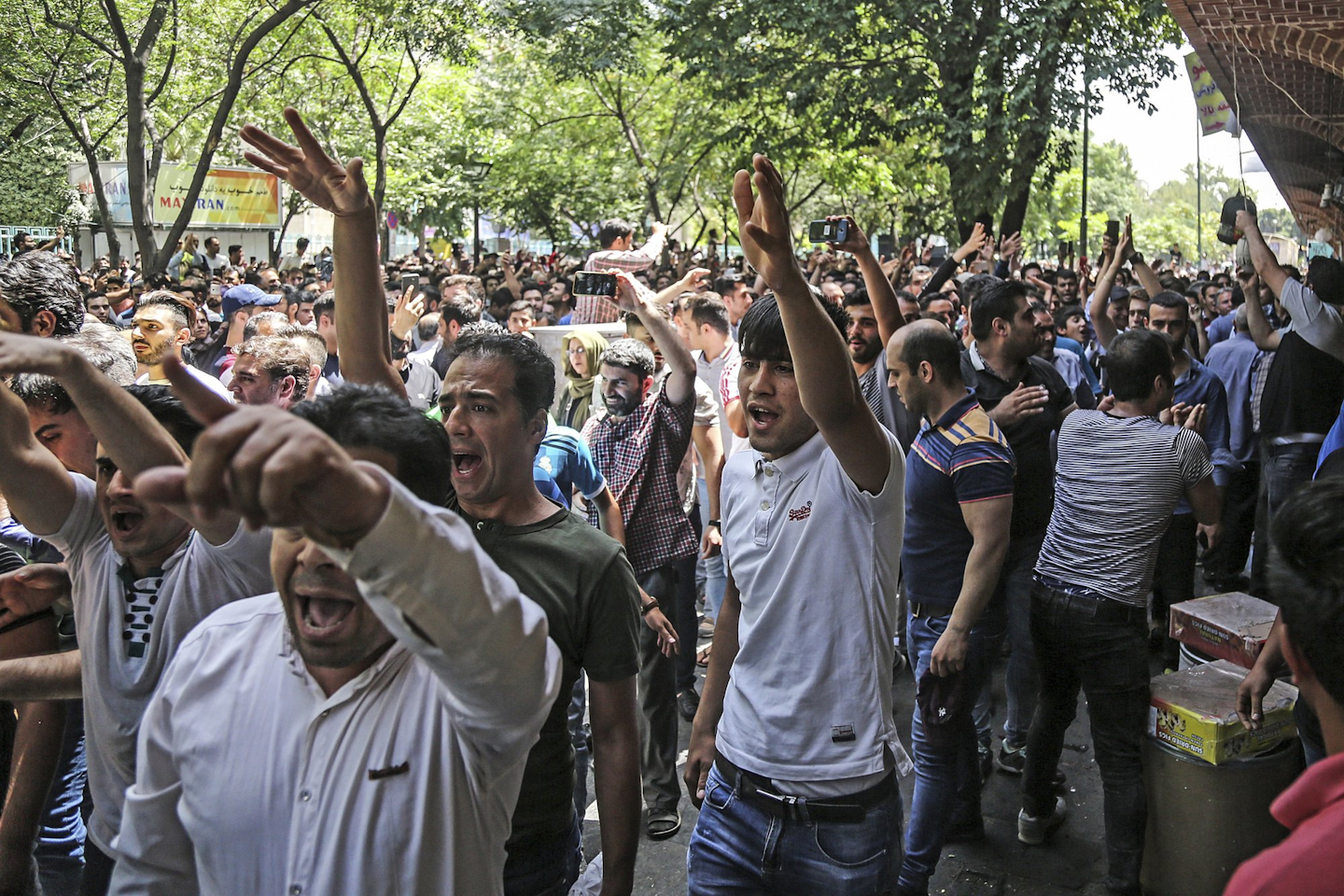 In this June 25, 2018 file photo, a group of protesters chant slogans at the old grand bazaar in Tehran, Iran. Iran is bracing for the restoration of U.S. sanctions on its vital oil industry set to take effect on Monday, Nov. 5, 2018, as it grapples with an economic crisis that has sparked sporadic protests over rising prices, corruption and unemployment. The oil sanctions will target the country’s largest source of revenue in the most punishing action taken since the Trump administration withdrew from the 2015 nuclear agreement in May. (Iranian Labor News Agency via AP)