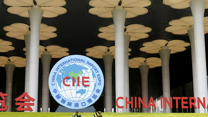 In this Oct. 26, 2018, photo, workers prepare a lawn outside the venue for the upcoming China International Import Expo in Shanghai. Image credit: Chinatopix via AP