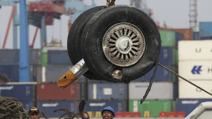In this Saturday, Nov. 3, 2018, file photo, a crane moves a pair of wheels recovered from the Lion Air jet that crashed into the Java Sea for further investigation at Tanjung Priok Port in Jakarta, Indonesia. Image credit: