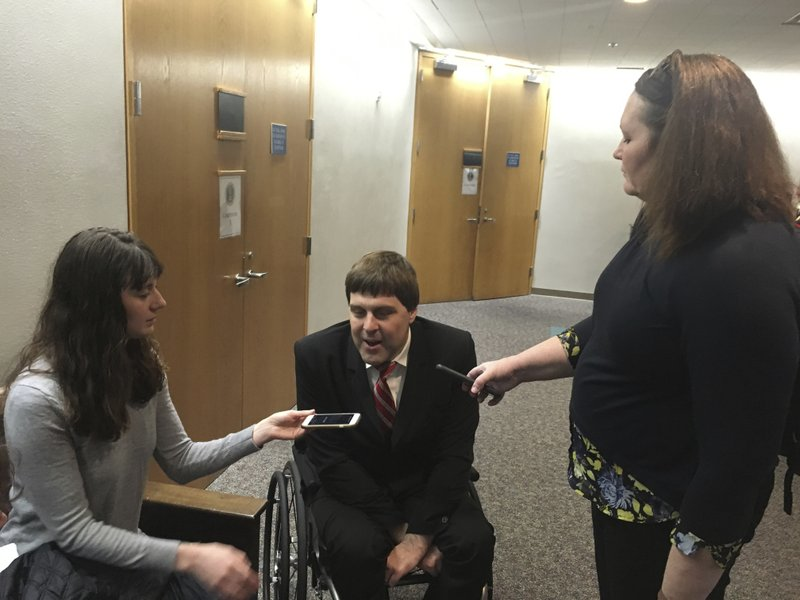 Erik Grafe, center, an attorney for Earthjustice, speaks to reporters following a hearing Friday, Nov. 9, 2018, in U.S. District Court in Anchorage, Alaska. Earthjustice and other environmental groups claim President Donald Trump exceeded his authority when he reversed a ban on offshore drilling in vast parts of the Arctic Ocean and in dozens of underwater canyons in the Atlantic Ocean. (AP Photo/Mark Thiessen)
