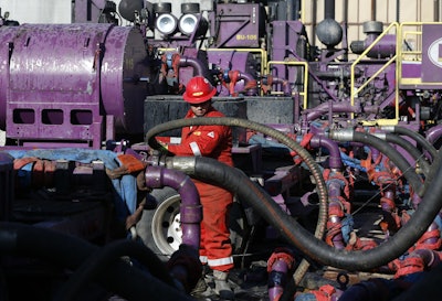 In this March 25, 2014 file photo, a worker adjusts hoses during a hydraulic fracturing operation at a gas well, near Mead, Colorado. The U.S. Environmental Protection Agency is holding its only public hearing on the Trump administration's plans to roll back Obama-era rules for methane pollution from the oil and gas industry. Nearly 125 people have asked to speak at the daylong session in Denver on Wednesday, Nov. 14, 2018. (AP Photo/Brennan Linsley)