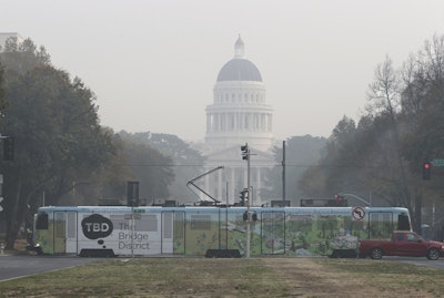 A light-rail train passes in front of the smoke shrouded state CapitolThursday, Nov. 15, 2018, in Sacramento, Calif. Smoke from the Camp Fire that burned through the Butte County city of Paradise is creating a health hazard that experts say could lead to an increase in serious health problems, especially for children and the elderly. (AP Photo/Rich Pedroncelli)