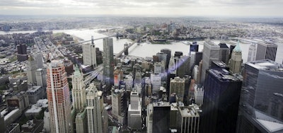 This May 20, 2015, file photo, shows New York's Financial District, foreground, the Brooklyn Bridge and East River, center, and in the distance Brooklyn as seen from the observatory at One World Trade Center. Image credit: AP Photo/Mark Lennihan, File