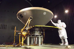 In this 2015 photo made available by NASA, a technician prepares the InSight spacecraft for thermal vacuum testing in its 'cruise' configuration for its flight to Mars, simulating the conditions of outer space at Lockheed Martin Space Systems in Denver. Image credit: NASA/JPL-Caltech/Lockheed Martin via AP