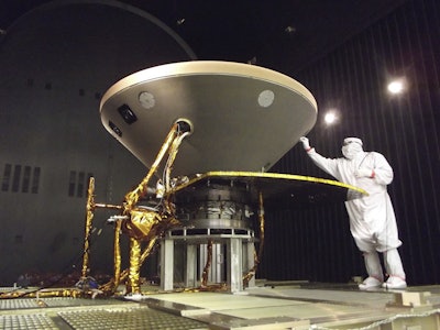In this 2015 photo made available by NASA, a technician prepares the InSight spacecraft for thermal vacuum testing in its 'cruise' configuration for its flight to Mars, simulating the conditions of outer space at Lockheed Martin Space Systems in Denver. Image credit: NASA/JPL-Caltech/Lockheed Martin via AP