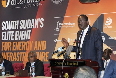 In this photo taken Tuesday, Nov. 20, 2018, South Sudan's Minister of Petroleum Ezekiel Lol Gatkuoth welcomes potential investors during the second Africa Oil and Power conference in the capital Juba, South Sudan. South Sudan is making its first big foreign investment pitch since declaring an end to its civil war, but the oil-rich nation seems to face hesitation from some companies that want to make sure the fragile new peace deal holds. (AP Photo/Sam Mednick)
