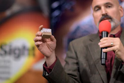 In a photo provided by NASA, Tim Priser, quality director at Lockheed Martin Space Systems, shows a small piece of the type of heat shield used on the Mars InSight, during a social media briefing Sunday, Nov. 25, 2018, at NASA's Jet Propulsion Laboratory in Pasadena, Calif. Image credit: Bill Ingalls/NASA via AP