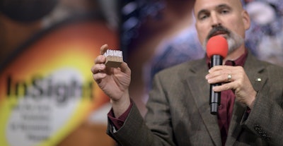 In a photo provided by NASA, Tim Priser, quality director at Lockheed Martin Space Systems, shows a small piece of the type of heat shield used on the Mars InSight, during a social media briefing Sunday, Nov. 25, 2018, at NASA's Jet Propulsion Laboratory in Pasadena, Calif. Image credit: Bill Ingalls/NASA via AP