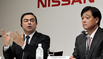 In this this Dec. 14, 2010 file photo, then Nissan Motor Co. President and CEO Carlos Ghosn, left, speaks as then Mitsubishi Motors Corp. President Osamu Masuko looks on during their joint press conference in Tokyo. Image credit: AP Photo/Koji Sasahara, File
