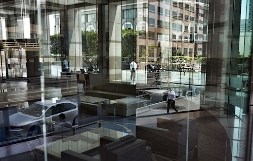 In this Aug. 27, 2018, file photo buildings and officer workers are reflected on windows in downtown Los Angeles. Image credit: AP Photo/Richard Vogel, File