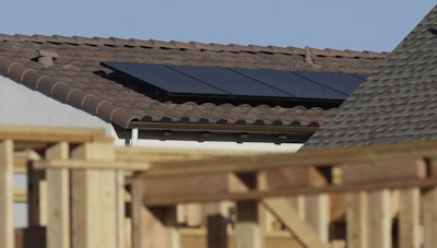 In this photo file taken Monday, May 7, 2018, solar panels are seen on the rooftop on a home in a new housing project in Sacramento, Calif. California is the first state in the nation to require homes built in 2020 and later be solar powered. The Building Standards Commission voted unanimously Wednesday, Dec. 5, 2018, to add the energy standards to the state building code. (AP Photo/Rich Pedroncelli)