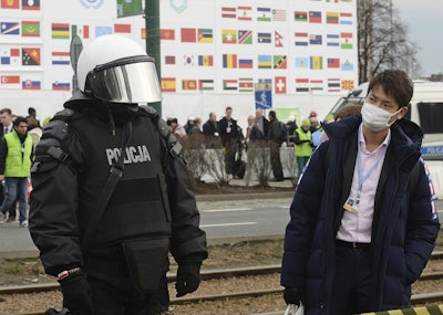 A climate conference participant looks at a police officer during the March for Climate, a protest against global warming in Katowice, Poland, Saturday, Dec. 8, 2018, as the COP24 UN Climate Change Conference takes place in the city. Image credit: AP Photo/Alik Keplicz