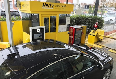 In this Friday, Dec. 7, 2018, photo, a Hertz 'Fast Lane' sign directs rental car drivers to a biometric scanning machine at Hartsfield-Jackson Atlanta International Airport, in Atlanta. Image credit: AP Photo/Jeff Martin