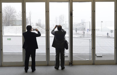 Negotiators at a U.N. climate summit take photos of snow that fell in the morning in Katowice,Poland, Tuesday, Dec. 11, 2018. Image credit: AP Photo/Czarek Sokolowski