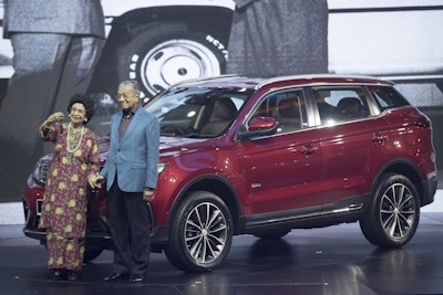Malaysia Prime Minister Mahathir Mohamad, right, poses with his wife Siti Hasmah during the launch of Proton new SUV in Kuala Lumpur, Malaysia, Wednesday, Dec. 12, 2018. Image credit: AP Photo/Vincent Thian