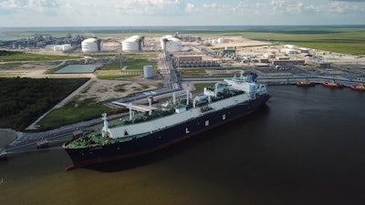 In this July 6, 2018 photo, a carrier ship for liquefied natural gas (LNG) is docked at Cheniere’s Sabine Pass Terminal in Cameron Parish, La. By specifically promoting LNG exports, the U.S. government is helping guarantee the success of a handful of companies _ using taxpayer dollars to boost a nascent industry it also regulates. Houston-based Cheniere has benefited from the government’s LNG push. (Kevin Clancy/Newsy via AP)