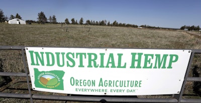 In this April 23, 2018 file photo, a sign designates the type of crop grown in a field as it stands ready to plant another hemp crop for Big Top Farms near Sisters, Ore. Image credit: AP Photo/Don Ryan, File