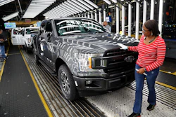 In this Sept. 27, 2018, file photo United Auto Workers' assemblyman Kelly Coman gives a final look to an assembled 2018 Ford F-150 truck on the assembly line at the Ford Rouge assembly plant in Dearborn, Mich. Image credit: AP Photo/Carlos Osorio, File