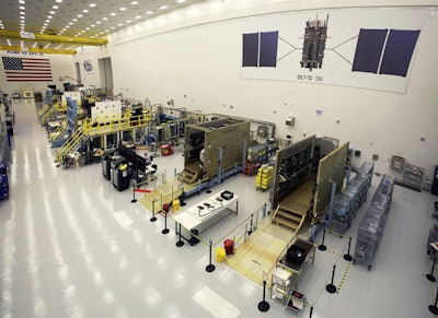 This June 23, 2017 photo provided by Lockheed Martin shows the second GPS III satellite during testing of the deployment of its solar arrays in a clean room at Lockheed Martin's complex south of Denver. Image credit: Pat Corkery/Lockheed Martin via AP