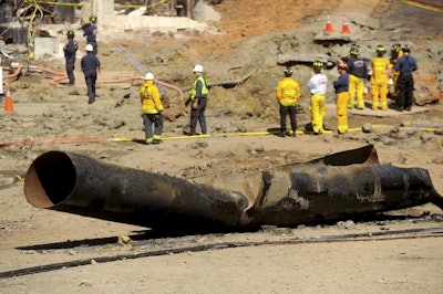 In this Sept. 11, 2010, file photo, a natural gas line lies broken on a San Bruno, Calif., road after a massive explosion. The California Public Utilities Commission said Friday, Dec. 14, 2018, that an investigation by its staff found Pacific Gas & Electric Co. lacked enough employees to fulfill requests to find and mark natural gas pipelines. A U.S. judge fined the utility $3 million after it was convicted of six felony charges for failing to properly maintain a natural gas pipeline that exploded south of San Francisco in 2010, killing eight people. (AP Photo/Noah Berger)