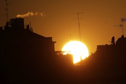 The sun sets over buildings in Milan, Italy, Friday, Dec. 14, 2018. Image credit: AP Photo/Luca Bruno