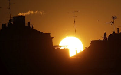 The sun sets over buildings in Milan, Italy, Friday, Dec. 14, 2018. Image credit: AP Photo/Luca Bruno