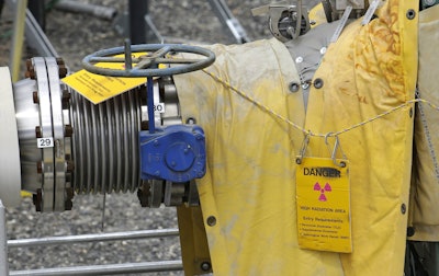 In this July 9, 2014 file photo, a sign warns of high levels of radiation near a valve at the 'C' tank farm during a media tour of the Hanford Nuclear Reservation near Richland, Wash. Conservation groups are alarmed by the Trump administration's proposal to rename some radioactive waste left from the production of nuclear weapons to make it cheaper and easier to achieve permanent disposal. The U.S. Department of Energy is considering a change in its legal definition of high-level radioactive waste, which is stored at places like the Hanford. (AP Photo/Ted S. Warren)