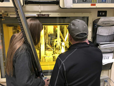 In this Nov. 29, 2018 photo, hot cell operators Dawnette Hunter, left, and Scot White manipulate radioactive material from behind 4-foot-thick leaded glass at the Hot Fuel Examination Facility at the Idaho National Laboratory about 50 miles west of Idaho Falls, Idaho. (AP Photo/Keith Riddler)