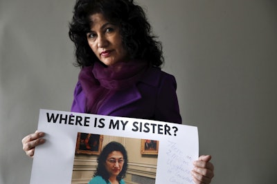 Rushan Abbas, 51, of Herndon, Va., holds a photo of her sister, Gulshan Abbas, Monday, Dec. 17, 2018, in Washington. Image credit: AP Photo/Jacquelyn Martin