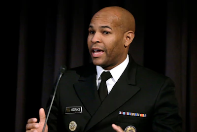 In this Dec. 6, 2018, file photo, United States Surgeon General Jerome Adams addresses an audience during a national summit focused on police efforts to address the opioid epidemic at Harvard Medical School in Boston. Image credit: AP Photo/Steven Senne, File