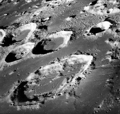 This Dec. 29, 1968 photo made available by NASA shows the large moon crater Goclenius, foreground, approximately 40 statute miles in diameter, and three clustered craters Magelhaens, Magelhaens A, and Colombo A, during the Apollo 8 mission. Image credit: NASA via AP, File