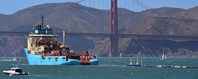 In this Sept. 8, 2018 file photo, a ship tows The Ocean Cleanup's first buoyant trash-collecting device toward the Golden Gate Bridge in San Francisco en route to the Pacific Ocean. The trash collection device deployed to corral plastic litter floating between California and Hawaii in an attempt to clean up the world's largest garbage patch is not collecting any trash. But Boyan Slat, who launched the Pacific Ocean cleanup project, told The Associated Press in an interview Monday, Dec. 17, 2018, he is confident the 2,000-foot (600-meter) long floating boom will be fixed. (AP Photo/Lorin Eleni Gill)