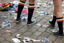 In this June 18, 2016 file photo two Belgian fans, wearing the Belgian colors, walk through plastic cups and other garbage after taking part in a celebration in Antwerp, Belgium, after Belgium won its Euro 2016 Group E match against Ireland. Image credit: AP Photo/Virginia Mayo, file