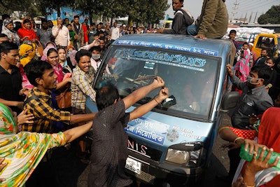 Bangladeshi garment workers vandalize a vehicle during a protest in Savar, on the outskirts of Dhaka, Bangladesh, Wednesday, Jan. 9, 2019. (AP photo)