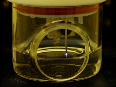 This is a graphic illustration showing protonated water reacting with nitrogen molecules to form ammonia at a plasma-liquid interface. (Case Western Reserve University)