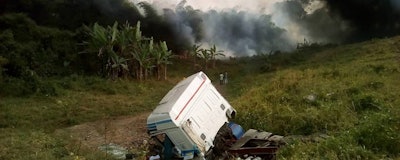 In this photo taken with a phone on Friday, Jan. 11, 2019, people gather at the site of an oil tanker explosion in Odukpani, Nigeria. An overturned oil tanker exploded in Nigeria while dozens of people were scooping up the leaking fuel and many were killed, police and witnesses said Saturday. (AP Photo )