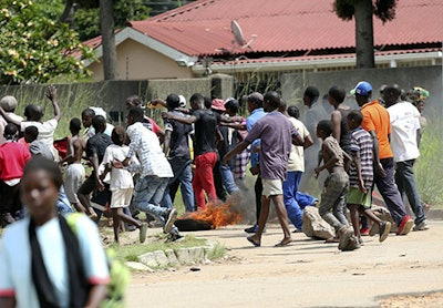 Protestors gather on the streets during demonstrations over the hike in fuel prices in Harare, Zimbabwe, Monday, Jan. 14, 2019. Protesters have blocked roads in some parts in Zimbabwe's capital after the government more than doubled the price of gasoline. (AP Photo/Tsvangirayi Mukwazhi)