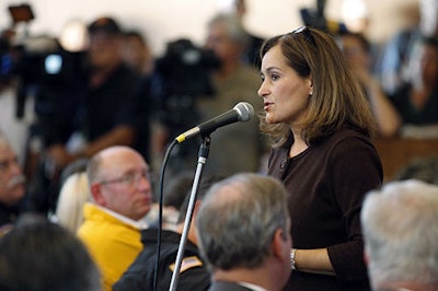 In this Sept. 11, 2010, file photo, Geisha Williams, right, then-senior vice president of energy delivery for Pacific Gas & Electric, speaks to hundreds of displaced San Bruno residents that jammed a town hall meeting at St. Roberts Catholic Church in San Bruno, Calif. PG&E said Sunday, Jan. 13, 2019, that CEO Williams was stepping down and that John Simon, the company's general counsel, would serve as interim CEO until a replacement is found. (AP photo/Tony Avelar)