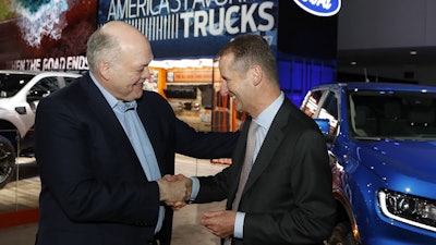 Ford Motor Co. President and CEO, Jim Hackett, left, meets with Dr. Herbert Diess, CEO of Volkswagen AG, Monday, Jan. 14, 2019, at the North American International Auto Show in Detroit. Image credit: AP Photo/Carlos Osorio