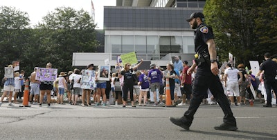 In this Aug. 17, 2018 file photo, family and friends who have lost loved ones to OxyContin and opioid overdoses protest outside Purdue Pharma headquarters in Stamford, Conn. Image credit: AP Photo/Jessica Hill, File