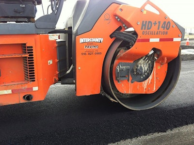 A machine compacts asphalt over existing pavement at a construction site at John F. Kennedy International Airport in New York City. (Hao Wang/Rutgers University-New Brunswick)