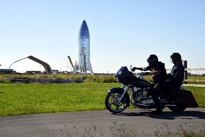 In this Jan. 17, 2017 file photo, people photograph the SpaceX Falcon 9 rocket booster as it makes its way into the port of Los Angeles. Image credit: Chuck Bennett/Orange County Register/SCNG via AP, File