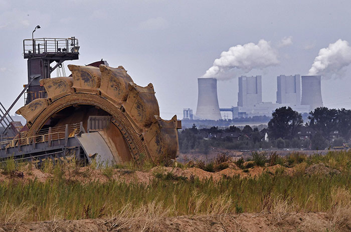In this photo taken Aug. 27, 2018 bucket wheel digs for coal near the Hambach Forest near Dueren, Germany. (AP Photo/Martin Meissner)