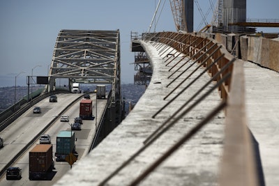 In this July 2, 2018, file photo, traffic moves on the old Gerald Desmond Bridge next to its replacement bridge under construction in Long Beach, Calif. Image credit: AP Photo/Jae C. Hong, File