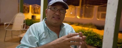 In this Dec. 10, 2018 photo, Nieves Ribullen speaks during a interview at his home in Punto Fijo, Venezuela. Ribullen, a Venezuelan oil worker sick of struggling to get by as his country falls apart, is betting it all on far-away job in Iraq's Kurdish region to give his family a better life.(AP Photo/Fernando Llano)
