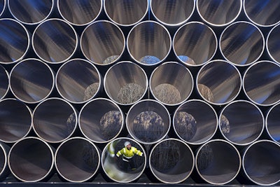 In this Dec. 6, 2016 file photo tubes are stored in Sassnitz, Germany, to construct the natural gas pipeline Nord Stream 2 from Russia to Germany. (Jens Buettner/dpa via AP)