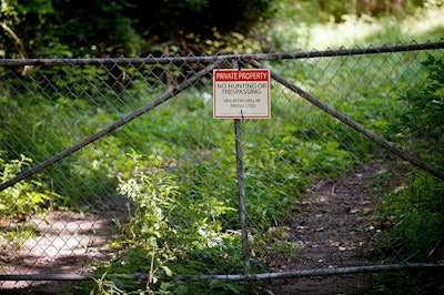 In this Aug. 16, 2017 file photo, a 'No trespassing' sign is displayed at an old tannery waste dump used by Wolverine World Wide in Belmont, Mich. Some private wells in the area have tested positive for elevated levels of perfluoroalkyl and polyfluoroalkyl substances called PFAS, also called perfluorinated chemicals, or PFCs. There’s growing evidence that long-term exposure to the perfluoroalkyl and polyfluoroalkyl compounds, or PFAS, can be dangerous, even in tiny amounts. The Environmental Protection Agency is looking at how to respond to a public push for stricter regulation of the chemicals, in production since the 1940s. A decision is expected soon. (Neil Blake /The Grand Rapids Press via AP)