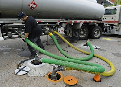 In this April 28, 2011 file photo, a truck delivers gas to a Citgo station in Wethersfield, Conn. U.S. refiners like Citgo are among the few customers paying cash for Venezuelan crude. Oil shipments to Venezuela’s other big customers, China and Russia, are usually taken as repayment for billions of dollars in debt. So the cash from Citgo has become a lifeline over the past two years as Venezuela’s oil output has plummeted amid chronic underinvestment in PDVSA and oil prices have dropped from historic highs. (AP Photo/Jessica Hill)
