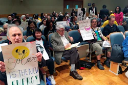 Opponents of a planned gas-fired power plant for eastern New Orleans are part of the crowd gathered for a city council committee hearing on Thursday, Feb. 14, 2019 in New Orleans. Image credit: AP Photo/Kevin McGill