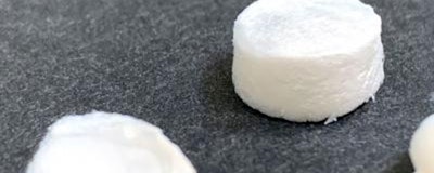 Breath mint-sized samples of the ceramic aerogels developed by a UCLA-led research team. The material is 99 percent air by volume, making it super lightweight. (UCLA Samueli Engineering)